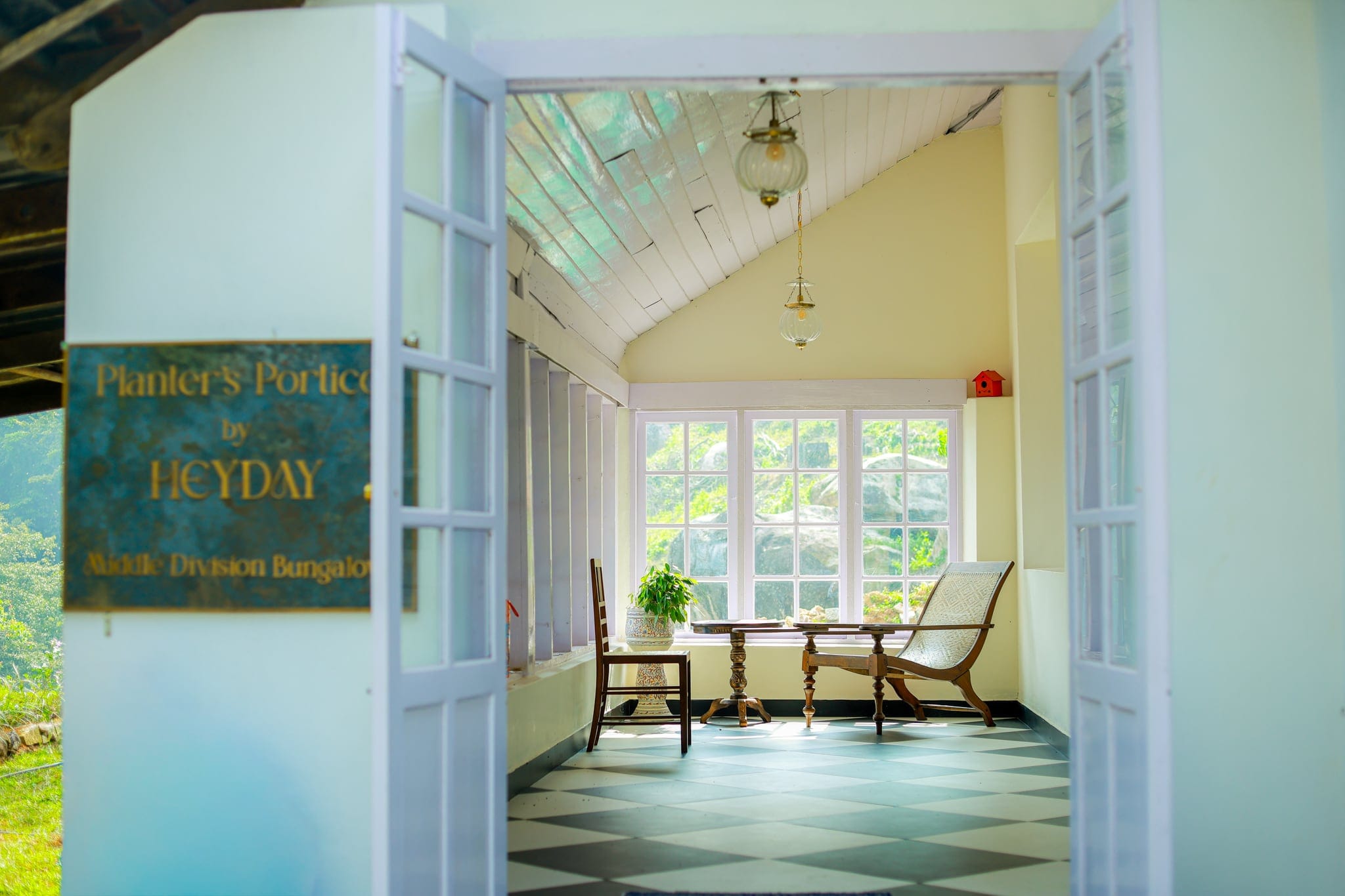 Bright verandah with cane chairs at Heyday Planter's Portico, near Thenmala, Kollam, Kerala
