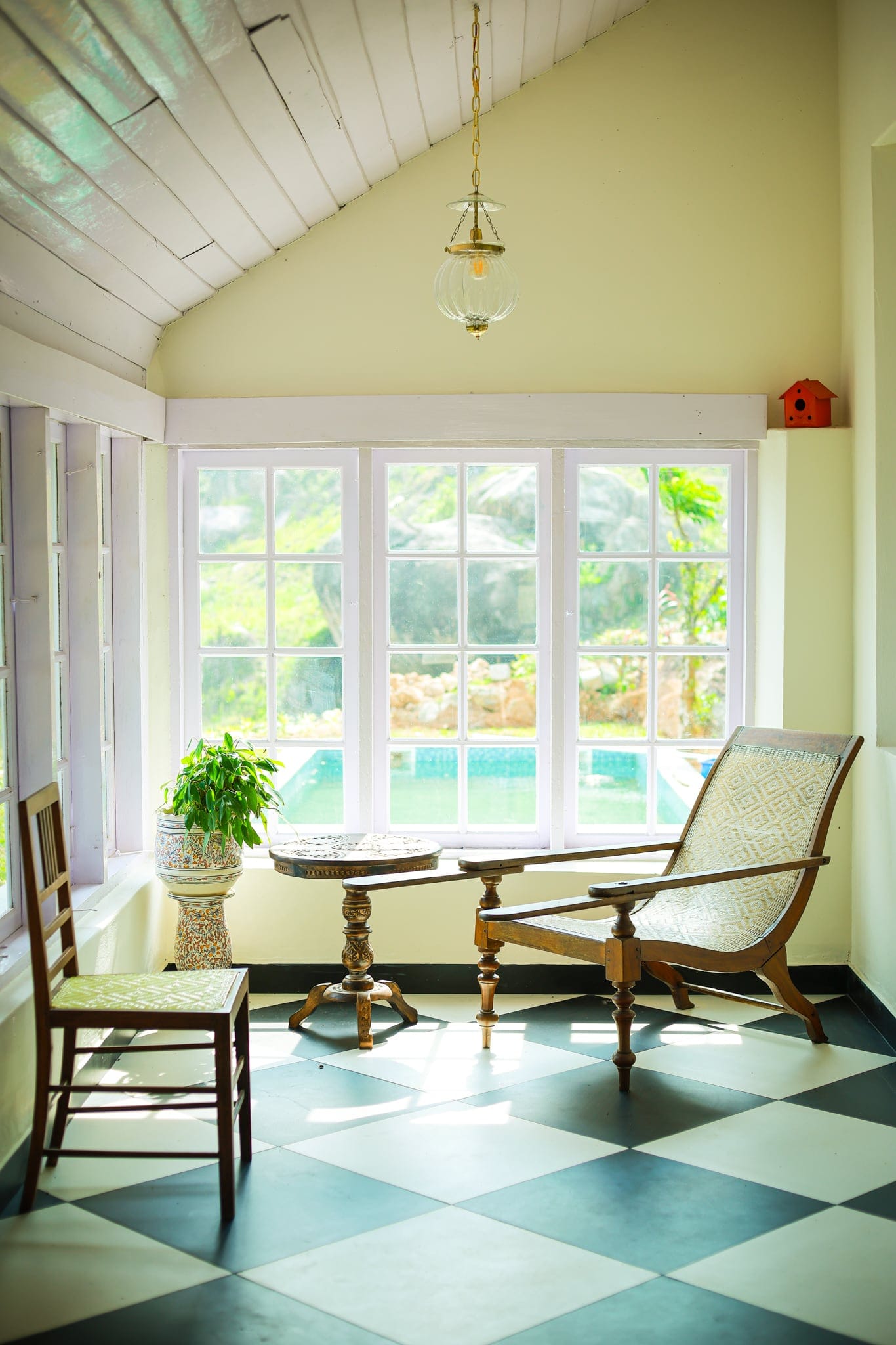 Verandah with planter's chairs opening to the garden at Heyday Planter's Portico, near Thenmala, Kollam, Kerala
